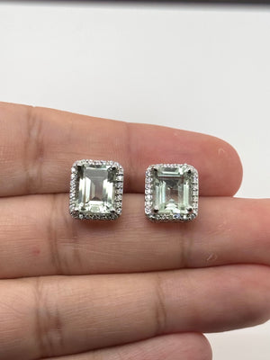 Flat lay green gemstone earrings with white gold setting minimalist luxury style