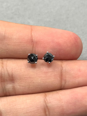 Elegant platinum black diamond stud earrings with round rose cut stones in AA quality, totaling 1.00 carat, four-prong setting and push backs, highlighting a modern solitaire look suitable for everyday women’s jewelry styling. 