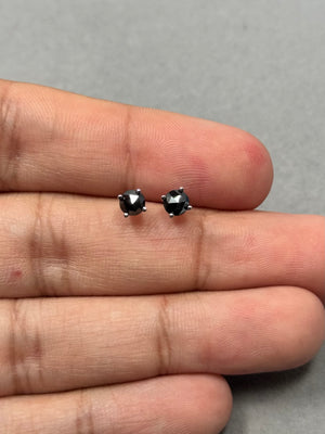 Elegant platinum stud earrings with round rose cut black diamonds, AA quality, 3/4 cts total weight. Four prong setting highlights the diamond surface, offering a timeless look suitable for everyday wear or understated formal styling. 
