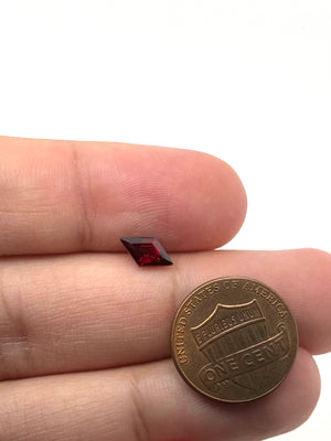 Garnet flat lay on neutral background highlighting deep red tone