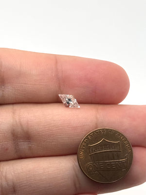 Clear gemstone ring flat lay with white gold band highlighting geometric minimalist jewelry style