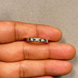 Channel set green and white diamond wedding band in 14k white gold