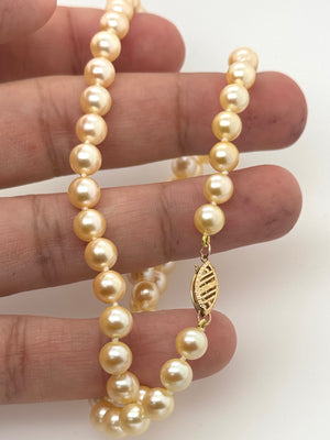 14K yellow gold clasp detail showing polished finish and premium necklace craftsmanship