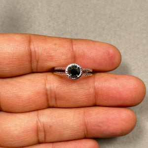 1 carat black diamond solitaire ring in polished 14K white gold with rhodium finish. Round AA grade black diamond measures 5.5 mm and is held in a classic prong setting. Elegant women’s fine jewelry ring with sleek minimalist band, bold dark gemstone contrast, modern timeless design, size 7 statement ring for everyday wear. 