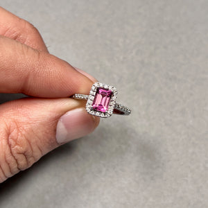 18K white gold ring with 1 ct AAA emerald cut pink tourmaline, medium pink tone, accented by 32 round diamonds totaling 0.26 ct, H SI grade, prong set design, rhodium finish, size 7, elegant structured gemstone ring with balanced brilliance and modern fine jewelry styling 