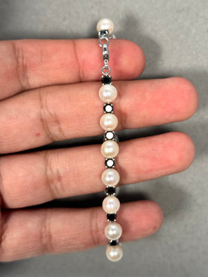 3.40 Ct Black Diamond and Akoya Cultured Pearl Bracelet in 14K White Gold, featuring 17 round AA black diamonds and luminous 6.5 mm white Akoya pearls. Elegant 7-inch bracelet with rhodium finish and lobster clasp, combining dark diamond sparkle with classic pearl radiance. 