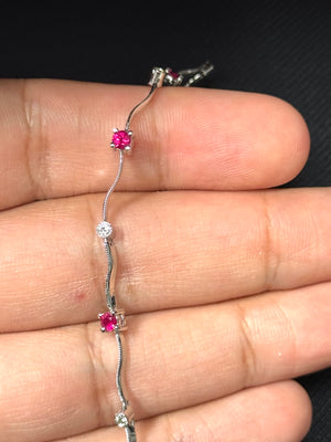 14K white gold ruby diamond bracelet featuring five AA-grade round rubies and five H-SI diamonds in a balanced prong-set sequence. Rhodium-finished, 7-inch length with 3.6 mm width, secured by a lobster claw clasp. Medium purplish-red rubies contrast with bright diamonds, creating a clean linear design suitable for everyday wear and refined minimal styling 