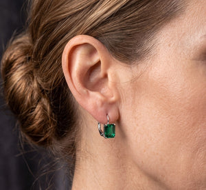Emerald stud earrings in 14K white gold featuring AAA emerald-cut lab-created emeralds in classic prong settings