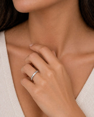 woman wearing thin diamond band on finger styled for wedding and everyday elegance
