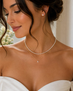 Woman wearing delicate Akoya pearl necklace layered for elegant bridal or everyday fashion styling